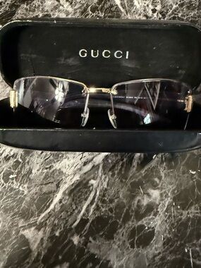Vintage Gucci GG1800S sunglasses featuring gold-tone metal frame and grey lenses